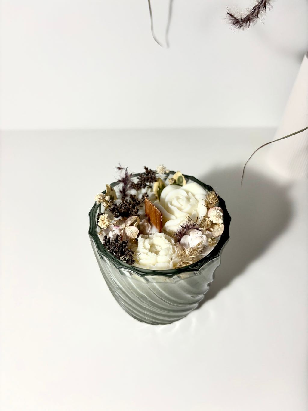 Žvakė stikliniame indelyje su gėlėmis